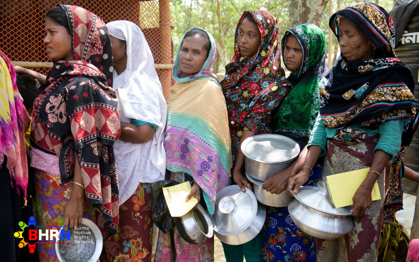 Rohingya refugees wait for food distribution at the Kutupalong transit center on April 16, 2018 in Cox's Bazar, Bangladesh. 